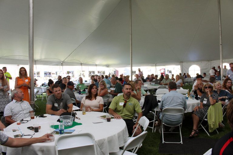 People in a tent for an outdoor gathering