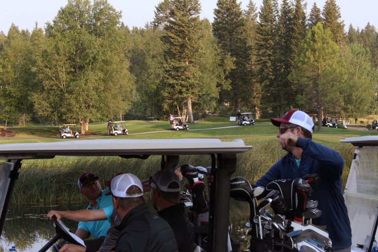 Golf carts going through a golf course